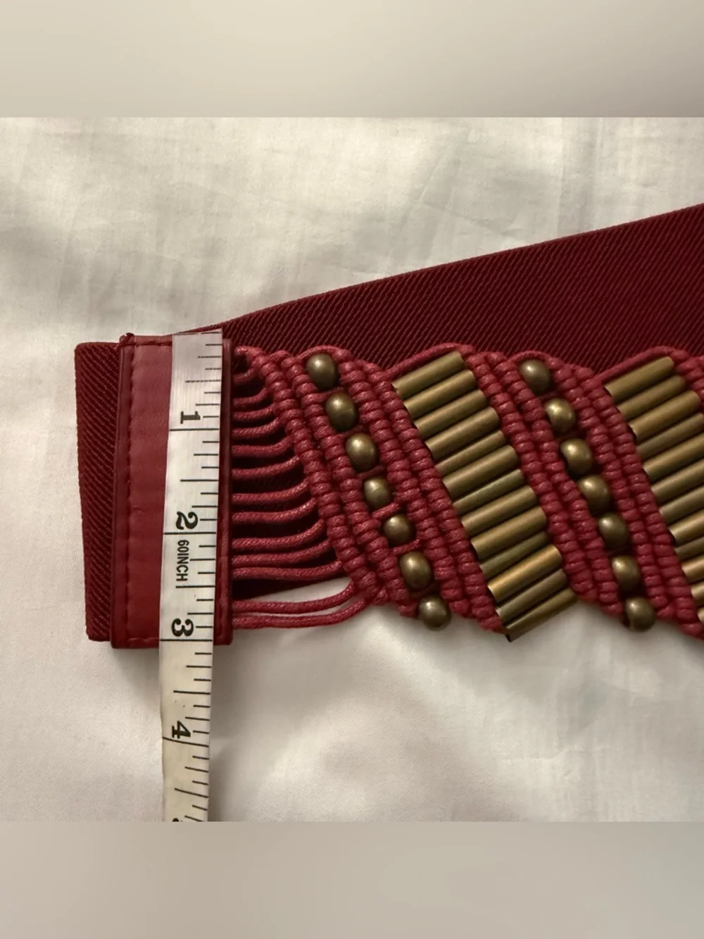 Burgundy elastic waistband belt with brass tone details